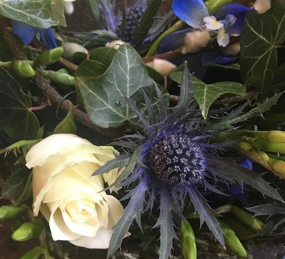 A woodland walk inspired our florists to create this funeral wreath. Crisp whites, lilacs and purples are with mixed with Ivy and seasonal foliage to make this elegant wreath. Available as pictured or a range of alternative colour choices.