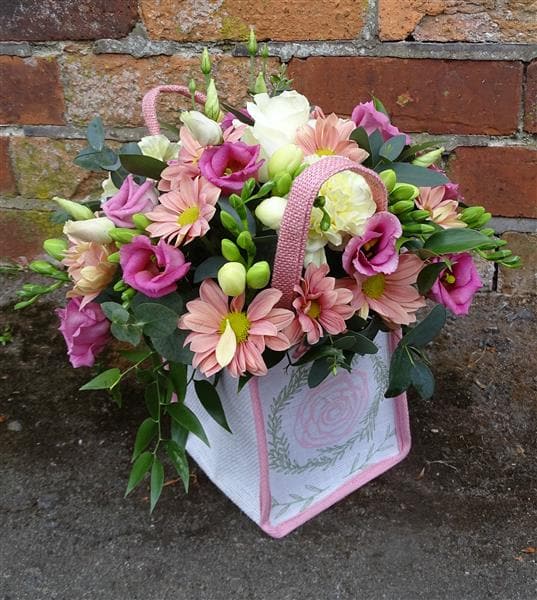 Raspberry Floral Bag Arrangement. This raspberry and cream arrangement is made up of a cream Rose and Freesia, pink Lisianthus, blush Chrysanthemums and seasonal flowers and foliage. What a gorgeous birthday or anniversary gift to give someone.