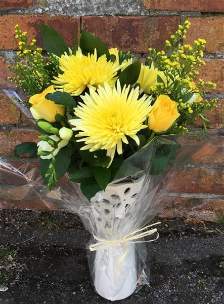 Danielle Steele Bouquet in a Vase. A fabulous vase, filled with yellow Ranunculi, Solidago, Lisianthus, Alstroemeria and white Chrysanthemums and seasonal flowers and foliages. It makes an ideal gift for a family celebrating the arrival of a new baby; a welcome for a new home; or cheer up someone who has just had an operation or is ill as well as for an anniversary, birthday or a little thank you.