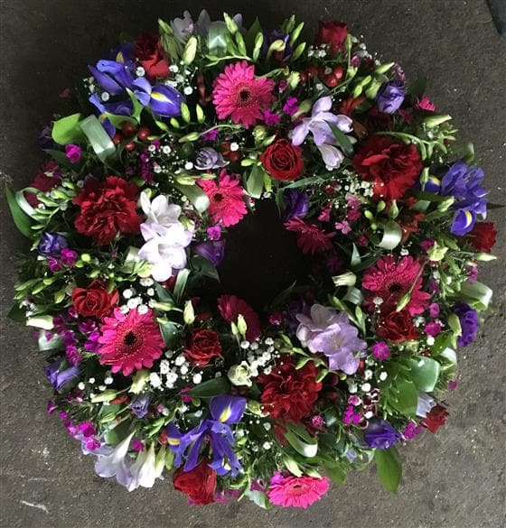 The Purple, Red & White Funeral Wreath is filled with colourful blooms, perfect tribute for a man or a woman.