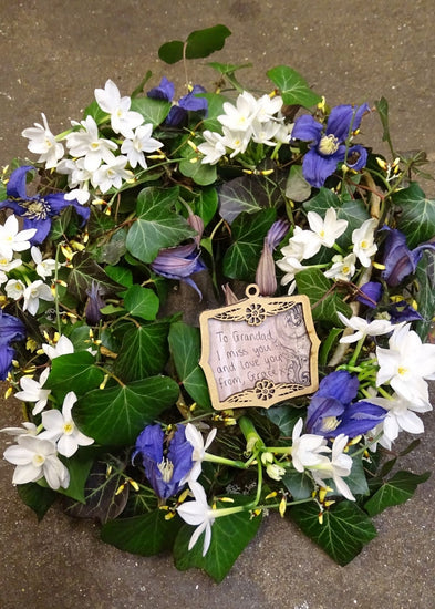 A woodland walk inspired our florists to create this funeral wreath. Crisp whites, lilacs and purples are with mixed with Ivy and seasonal foliage to make this elegant wreath. Available as pictured or a range of alternative colour choices.