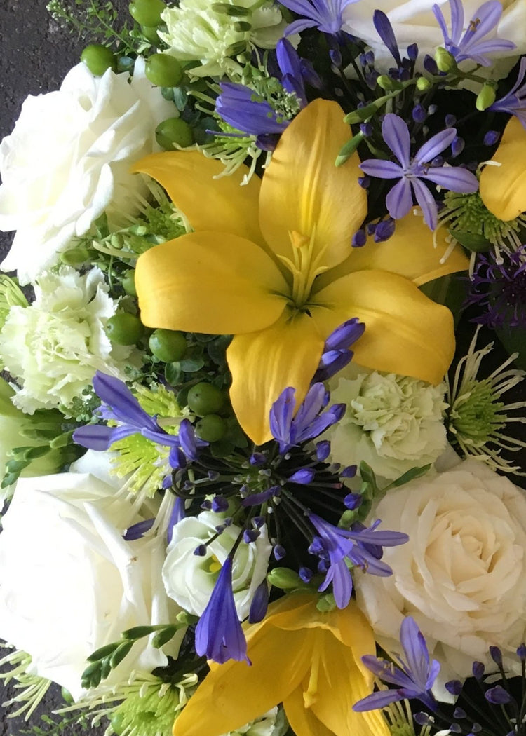 A yellow, purple and white bouquet of seasonal flowers for any occasion from Make Their Day. Same day delivery in and around Monday to Saturday order by 3pm This bouquet is gift wrapped in cellophane and finished with a raffia bow